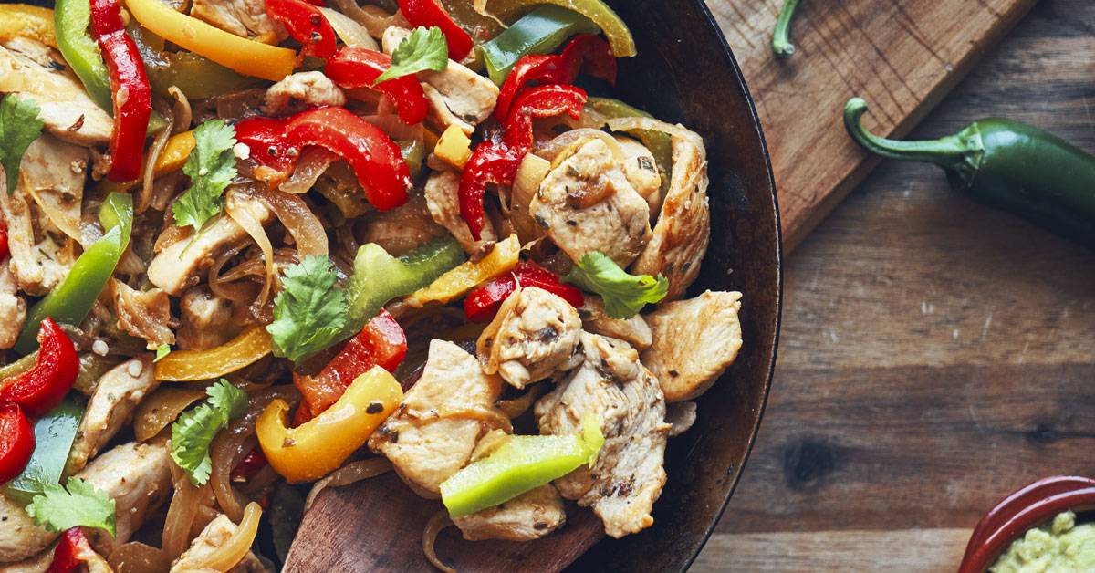 Chicken and peppers in a skillet